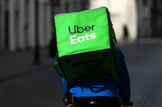 Gig economy shifts as Uber takes on supermarket delivery, government pushes for minimum employment standards